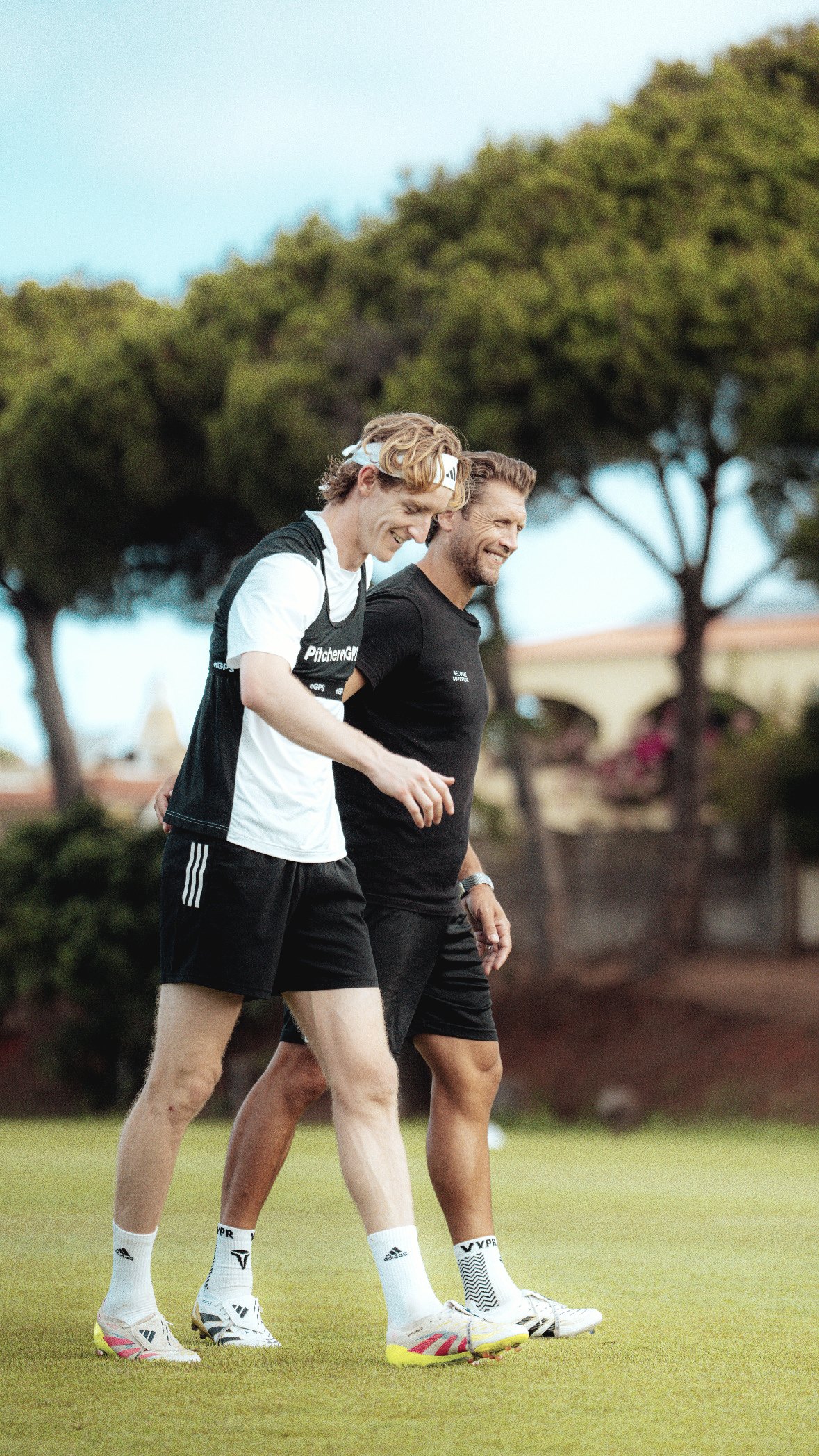 Allan Russell walking with a young developing striker
